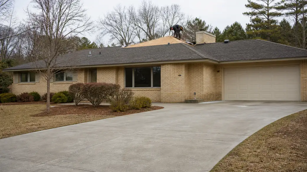 roof installation completed by a local contractor at a buff-brick ranch home in Madison, WI, under bright midday cloud.